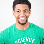 Portrait of a smiling young man wearing a green T-shirt with science text.